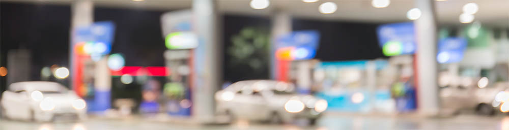 Blurry image of petrol station with cars parked at night