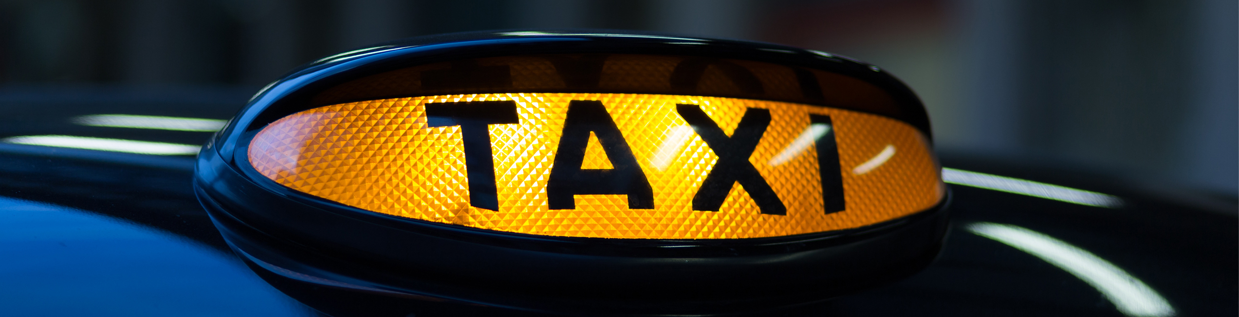 Up close picture of a black cab taxi sign